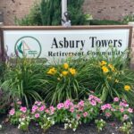Flowers in front of our Asbury Towers sign