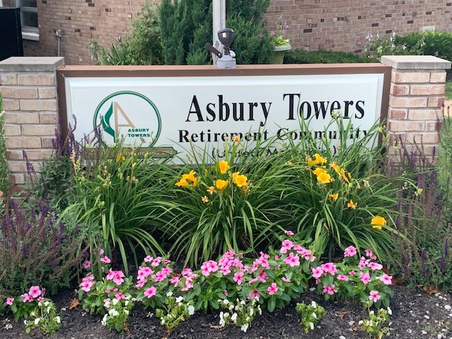 Flowers in front of our Asbury Towers sign