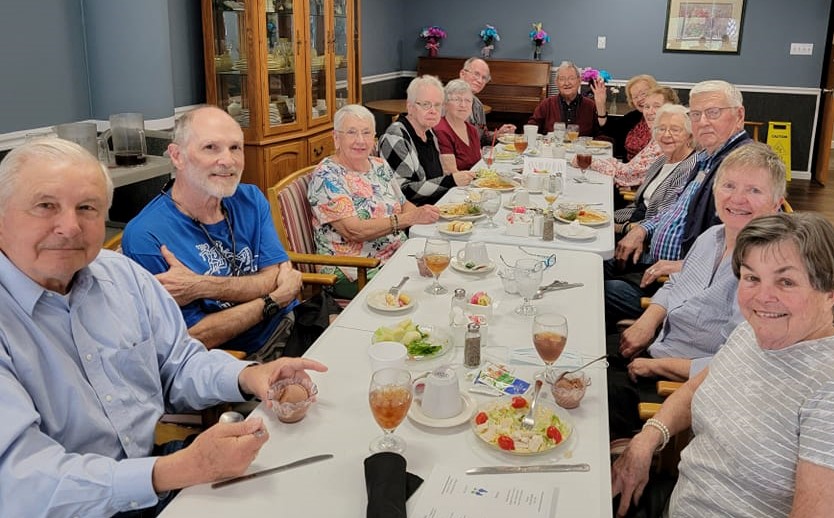 Residents eating at a table.